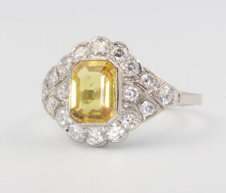 A platinum yellow sapphire and diamond ring, the centre stone approx. 1.40ct, the diamonds, size N 0.65ct