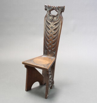 A Victorian carved oak spinning chair with solid back and seat, decorated mythical beasts 88cm h x 49cm w x 30cm d (seat 19cm x 23cm) 