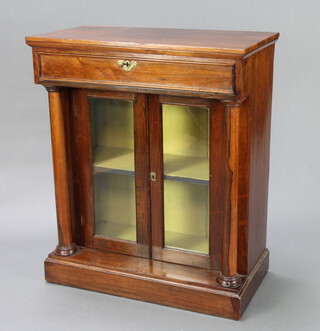 A William IV rosewood chiffonier fitted a drawer above a pair of glazed panelled doors, having turned Doric columns to the sides 102cm h x 87cm w x 43cm d 