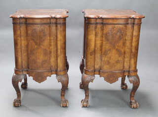 A pair of 19th Century Continental shaped inlaid walnut pedestal cupboards with moulded and dentil cornice, enclosed by inlaid shaped panelled doors raised on cabriole, ball and claw supports 99cm h x 60cm w x 60cm d