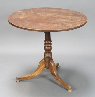 An 18th/19th Century circular oak tea table raised on a turned column and tripod base 71cm h x 80cm diam. (split to top, water damage, ink marks) 