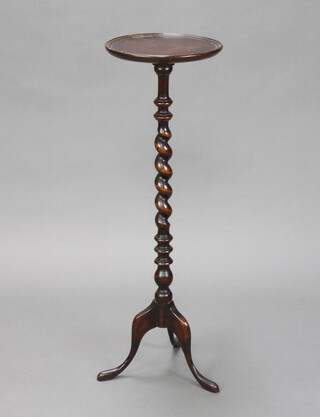 An Edwardian circular turned oak jardiniere stand raised on a spiral turned column and tripod base 90cm h x 29cm diam. (top has contact marks and a split) 
