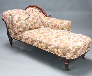 A Victorian carved mahogany show frame chaise longue with floral patterned loose cover, raised on turned supports 88cm h x 179cm l x 66cm w (seat 133cm x 49cm)