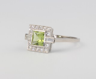 A platinum Art Deco style peridot and diamond ring, the central stone approx. 0.85ct, the diamond surround approx. 0.3ct, size O