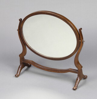 A Georgian style oval plate dressing table mirror contained in a mahogany swing frame 50cm h x 52cm w x 21cm d 