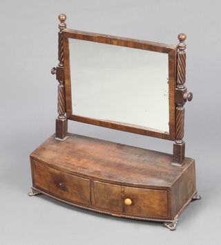 A William IV rectangular plate dressing table mirror contained in a mahogany frame on spiral turned columns to the side, the bow front base fitted 2 long drawers, raised on pressed gilt metal paw supports 51cm h x 46cm w x 20cm d 