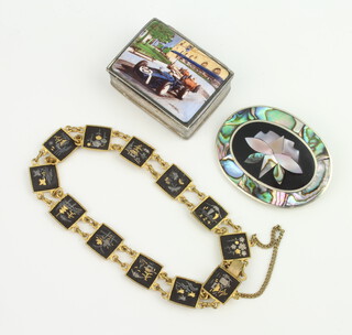 A modern silver pill box with enamelled motor racing scene 35mm, a bracelet and brooch 