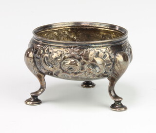 A Georgian silver table salt decorated with flowers on hoof feet, Scottish 76 grams, rubbed marks 