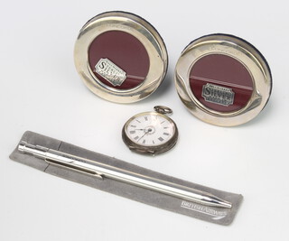 A pair of sterling silver circular Concorde photograph frames 6.5cm diam., a pen and fob watch  