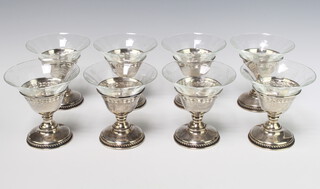 A set of 8 glass sundae dishes on sterling silver bases 10cm 