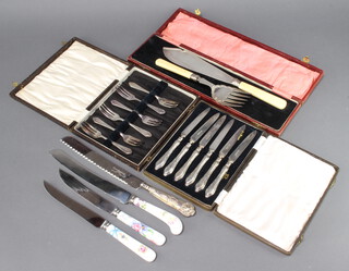 A pair of plated fish servers and minor cutlery 