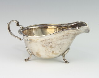 A silver sauce boat with scroll handle on hoof feet, Sheffield 1937, 96 grams