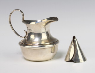 A silver cream jug with C scroll handle Birmingham 1912 together with a silver posy cup, 90 grams 