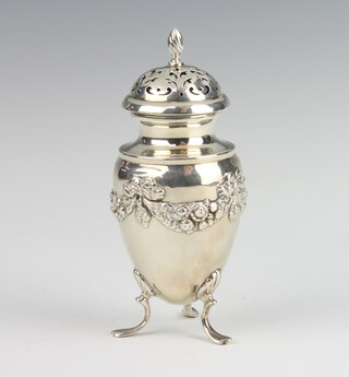 An Edwardian repousse silver pepperette raised on pad feet 76 grams, 12cm, rubbed hallmarks 