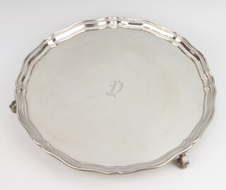 A silver salver with pie crust rim on scroll feet Chester 1936, engraved monogram 766 grams, 30cm 