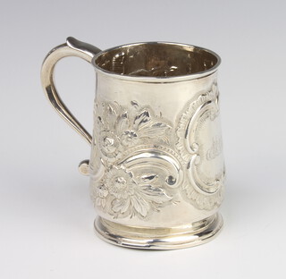 A George III repousse silver mug with engraved monogram and scrolling flowers with S scroll handle, London 1812, 9cm, 192 grams 