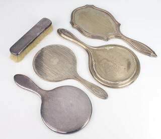 A silver backed hand mirror London 1911, 3 others and a clothes brush 