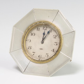 A 1920's Swiss 8 day bedroom timepiece with silvered dial and Arabic numerals contained in a silver octagonal case, 9cm  