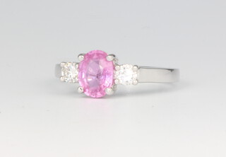 An 18ct white gold oval pink sapphire and diamond ring, the centre stone approx. 1.5ct, the diamonds 0.35ct, size N, 5.7 grams 