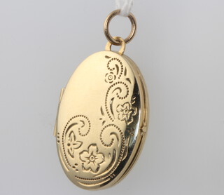 A 9ct yellow gold oval engraved locket 3.6 grams