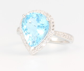 A 14ct white gold pear cut blue topaz and diamond ring, the centre stone approx. 4.7ct surrounded by brilliant cut diamonds and to the shoulders 0.45ct, 3.7 grams, size M 1/2