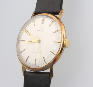 A gentleman's 9ct yellow gold Omega wristwatch, the dial inscribed Geneve, the reverse with presentation inscription contained in a 32mm case on a black leather strap 
