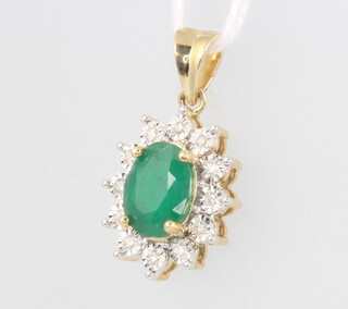 A 9ct yellow gold oval emerald and diamond cluster pendant 0.12ct of diamonds, approx 2ct emerald, 2.2 grams, 22mm