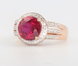 A 14ct rose gold ruby (treated) and diamond cluster ring, the centre stone approx. 4ct, the diamonds 0.48ct, 4.3 grams, size M 1/2
