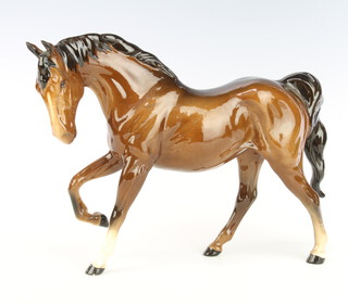 A Royal Doulton figure of a horse with right leg raised, gloss brown, 29cm 