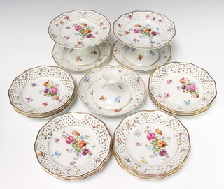 A 20th Century Dresden dessert service comprising 3 tazzas 19cm (1 damaged) and 14 plates, all with pierced decoration and decorated with spring flowers 
