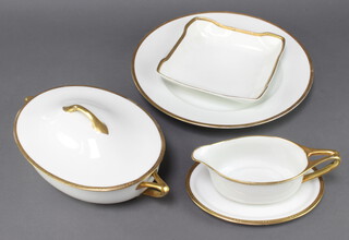 A Rosenthal dessert service with gilt rims comprising 21 dinner plates, 6 side plates, 6 small plates, 2 serving plates, 5 soup bowls, 3 shaped dishes, 4 graduated dishes, a tureen and cover, a sauce boat and an oval dish 