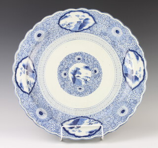 A Chinese blue and white charger with panels of landscape studies 47cm 