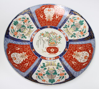 A Japanese Imari charger with panelled decoration, urn and flowers to the centre, 46cm diam. 