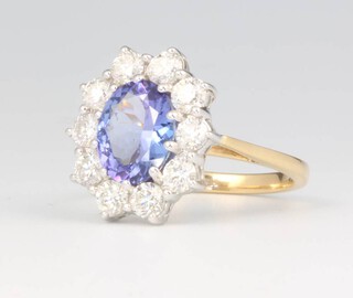 An 18ct yellow gold oval tanzanite and diamond cluster ring, the centre cut stone approx. 2.4ct surrounded by brilliant cut diamonds approx. 1.5ct, 5 grams, size P 1/2