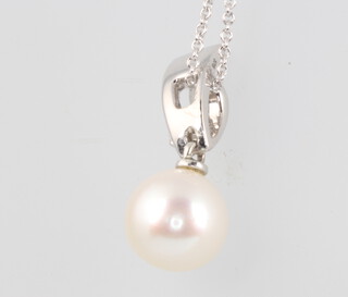 A 9ct white gold pearl and diamond pendant on a ditto chain 3.4 grams