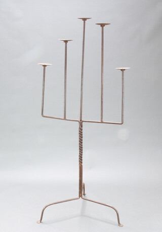 A wrought iron floor standing 5 light candelabrum 175cm h x 80cm, raised on a tripod base 