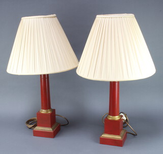 A pair of red and gilt painted metal column standard lamps complete with shades 40cm h x 13cm x 13cm 