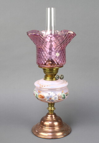 A Victorian opaque pink and floral painted oil lamp reservoir with shade and chimney, raised on a circular copper foot, the burner with sunburst mark 57cm h x 18cm diam. base
