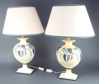 A pair of Continental pottery table lamps in the form of urns, raised on square bases 38cm x 17cm x 13cm 