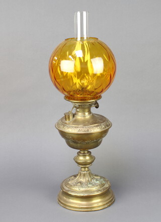 A 19th Century embossed gilt metal oil lamp with amber shade and clear glass chimney 59cm h x 18cm  