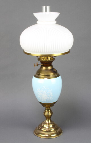 A 19th Century blue floral patterned porcelain and gilt metal mounted oil lamp, the burners marked Made in England Duplex with white opaque shade and clear glass chimney, raised on a circular foot 62cm h x 26cm diam.