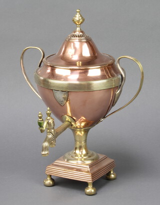 A Regency copper and brass tea urn with silver shield shaped cartouche and turned ivory handle, raised on bun feet 34cm h x 26cm 