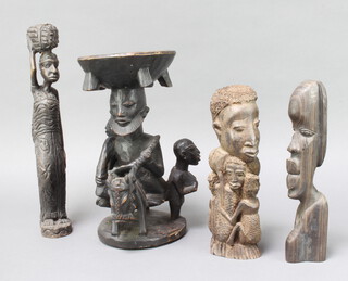 A carved African figure of a standing lady 37cm x 7cm x 5cm, a carved African portrait bust of a lady and children 26cm x 9cm x 7cm, ditto of a lady 27cm x 5cm x 4cm and ditto bowl supported by a figure of a gentleman with donkey and 2 supporters 32cm x 6cm 
