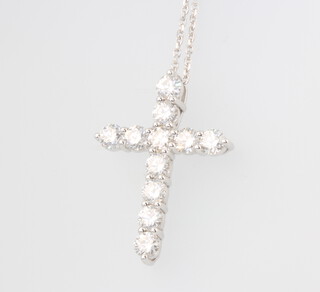 An 18ct white gold 11 stone brilliant cut diamond cross pendant and 18ct white gold chain, 6 grams, 2.3ct 