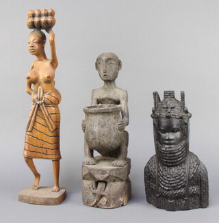 An Ashante carved portrait bust of a lady 30cm x 15cm x 8cm, carved African figure of a person seated by a cooking pot 37cm x 11cm x 17cm (chip to edge) and a carved African figure of a standing lady 50cm x 12cm x 11cm  
