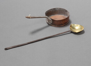 An 18th/19th Century brass and steel long handled basting spoon 59cm l, bowl 12cm x 10cm together with a copper saucepan with polished steel handle 6cm h x 9cm diam. 