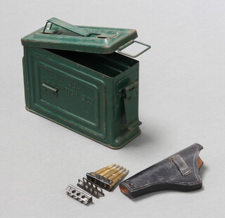 An American 30M1 metal ammunition box containing a black leather holster 19cm x 9cm x 2cm and various bullet clips  