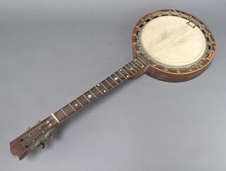 A 4 stringed banjo, the head marked The Windsor Popular Model no.7, back marked The New Windsor Patent Zither Banjo 
