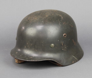 A Nazi German Q64 steel helmet complete with leather liner, the interior marked Q64 4649 