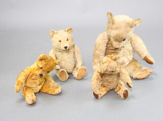 A yellow teddy bear with articulated limbs 64cm, together with 3 other bears 49cm, 44cm and 43cm 

